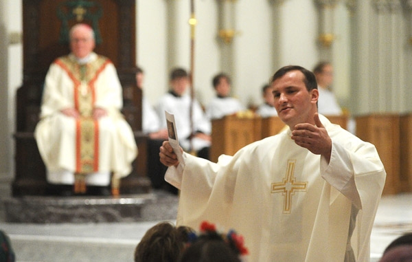 Framed by Bishop Richard J. Malone, Rev. Ryszard S. Biernat speaks about his Polish heritage during a mass celebrating 1,050 years of Polish commitment to the Catholic faith at St Joseph Cathedral in Downtown Buffalo. (Photo by Dan Cappellazzo)